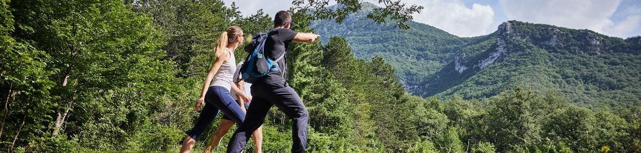 Hiking Retreat – Scenic Trail Walk Man and woman hiking together on a scenic trail during a hiking retreat