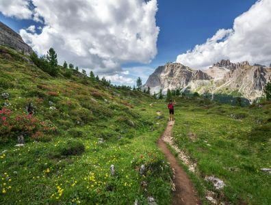 Nature Holiday – Scenic Mountain Walk Man walking along a path surrounded by mountains and hills during a nature holiday
