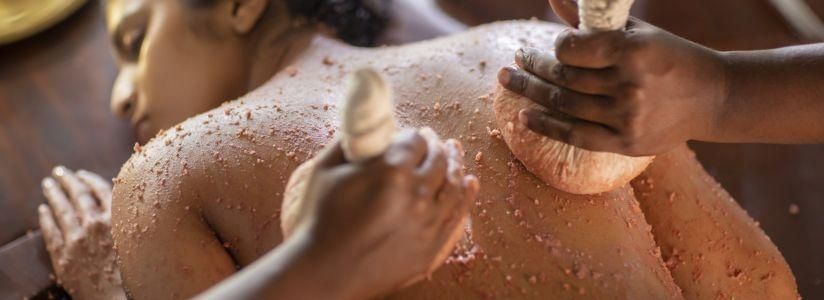 Ayurveda Retreat – Traditional Healing Treatment Woman receiving an Ayurveda treatment at a wellness retreat